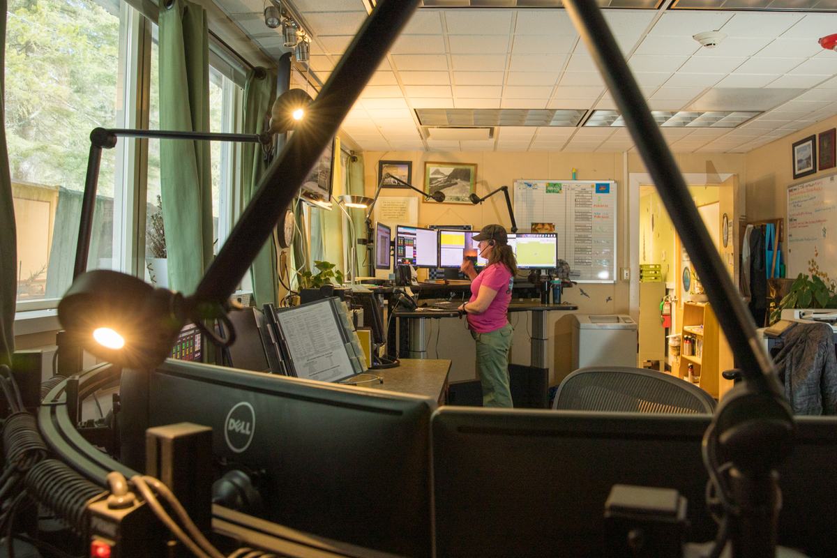 An emergency dispatch desk with monitors and radio equipment
