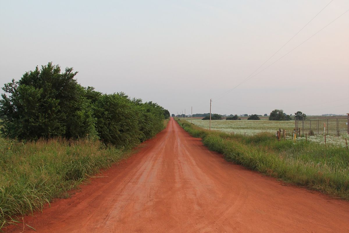 Red clay dirt road in rural Oklahoma, the expansive soil country around Bixby