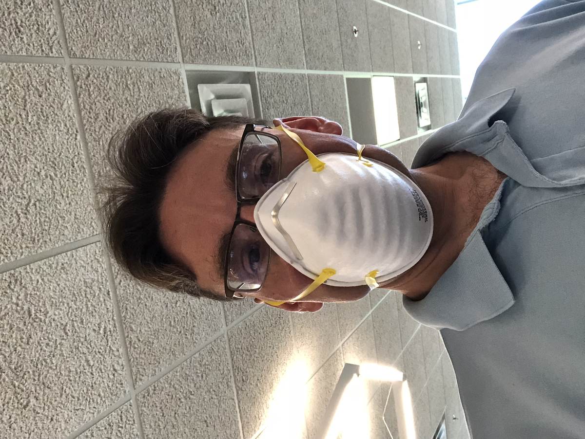 A man wearing a fitted respirator mask