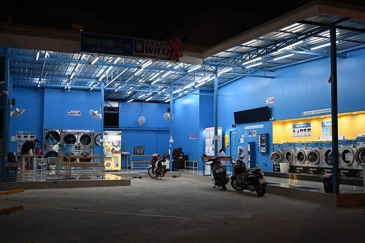 A row of washing machines in a laundromat, the source of Category 2 grey water in homes