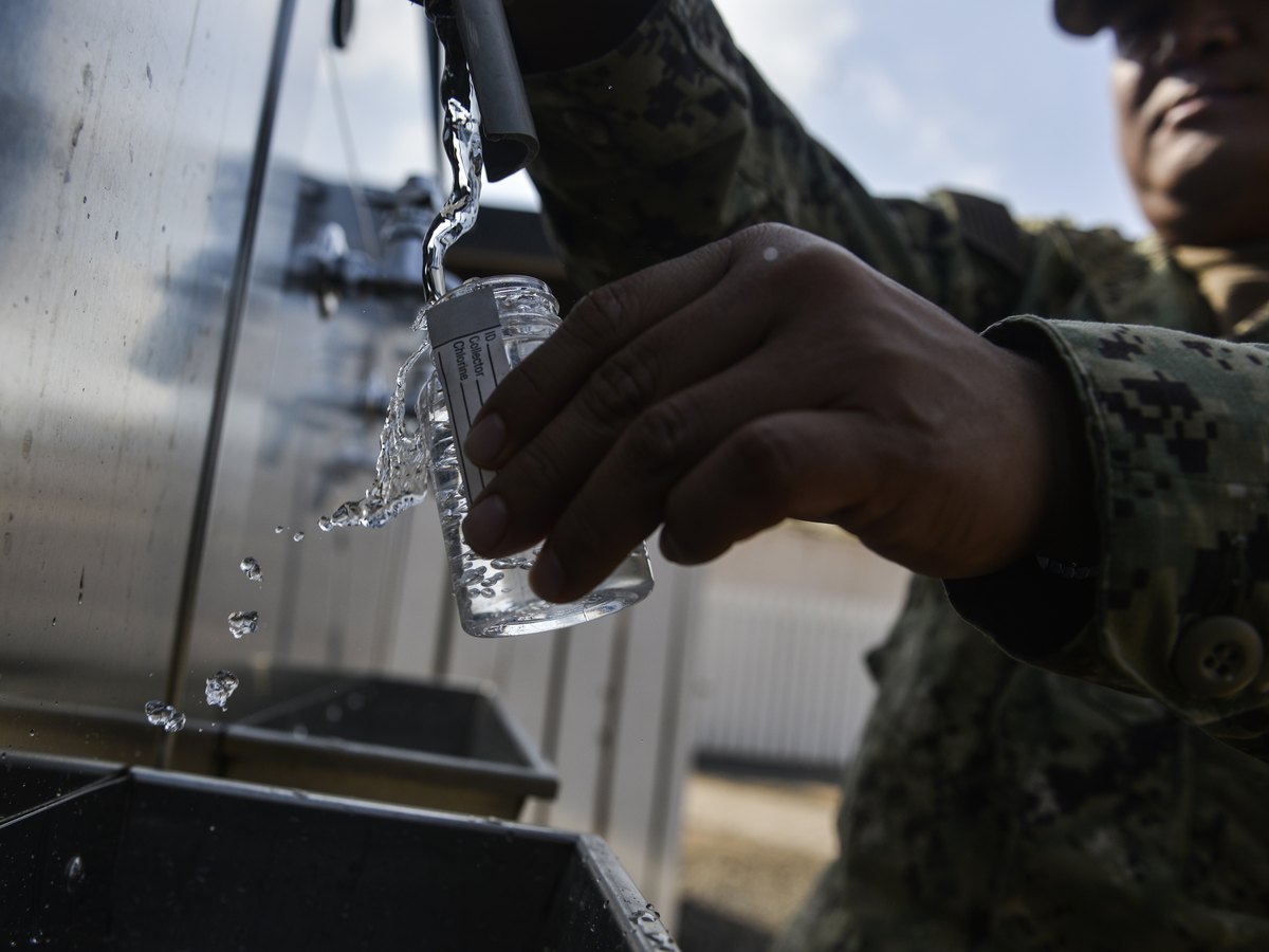 Water drawn into a glass for testing, the check that tells clean Category 1 water from contaminated water