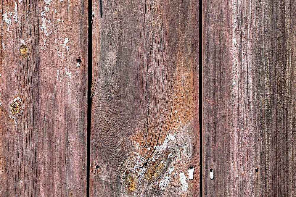 Weathered, water damaged wood boards showing long term moisture exposure
