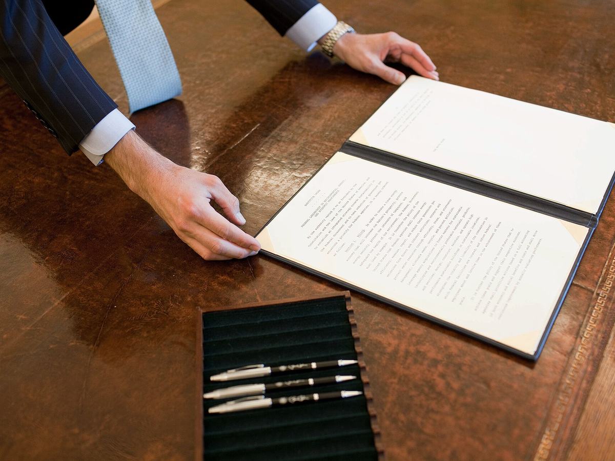 A document folder and pens on a desk, ready for working through the costs