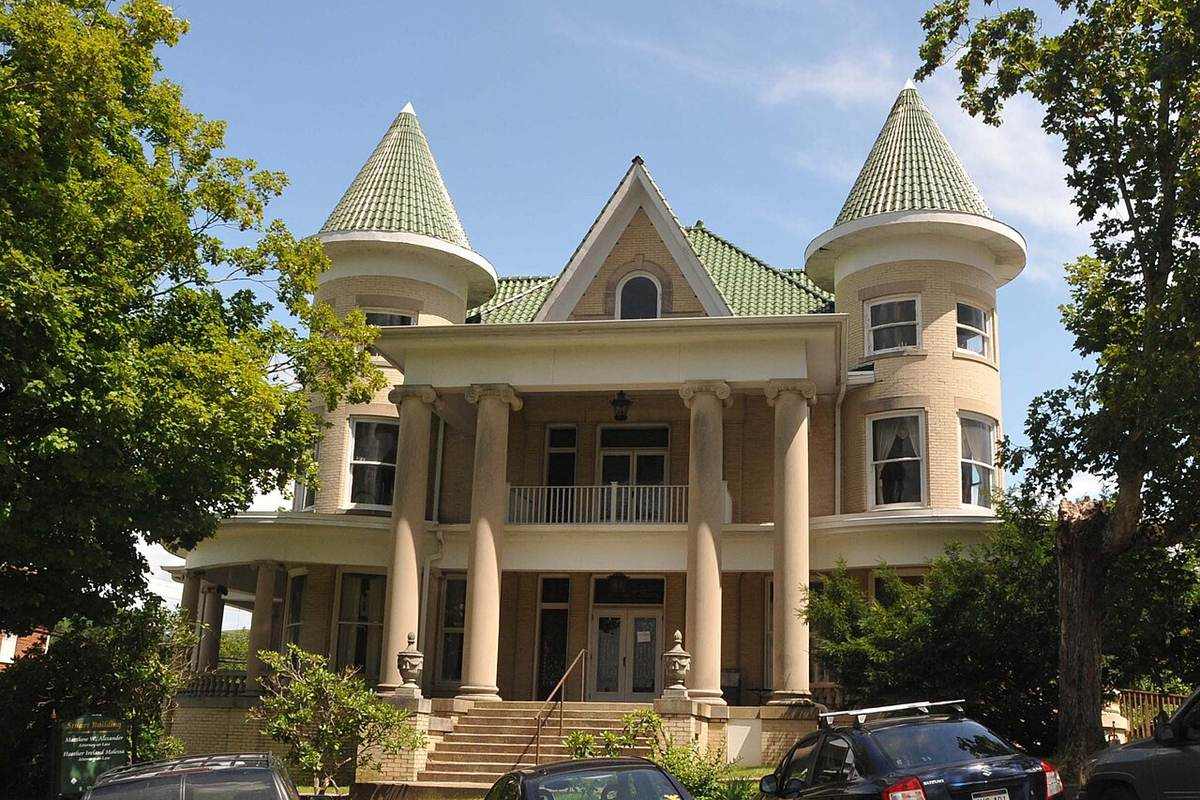A grand historic home with twin turrets in an established residential neighborhood