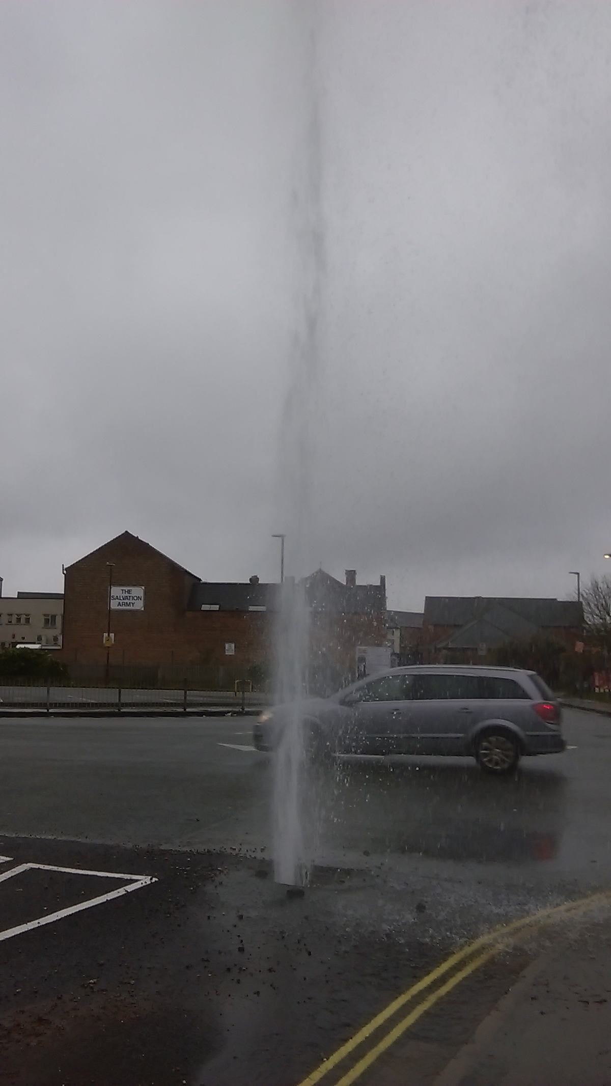 Water jetting into the air from a burst pipe outdoors