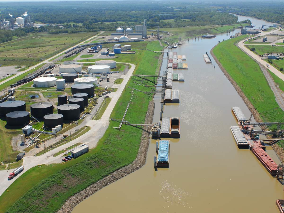 Barges and storage tanks along the navigation channel at the Tulsa Port of Catoosa