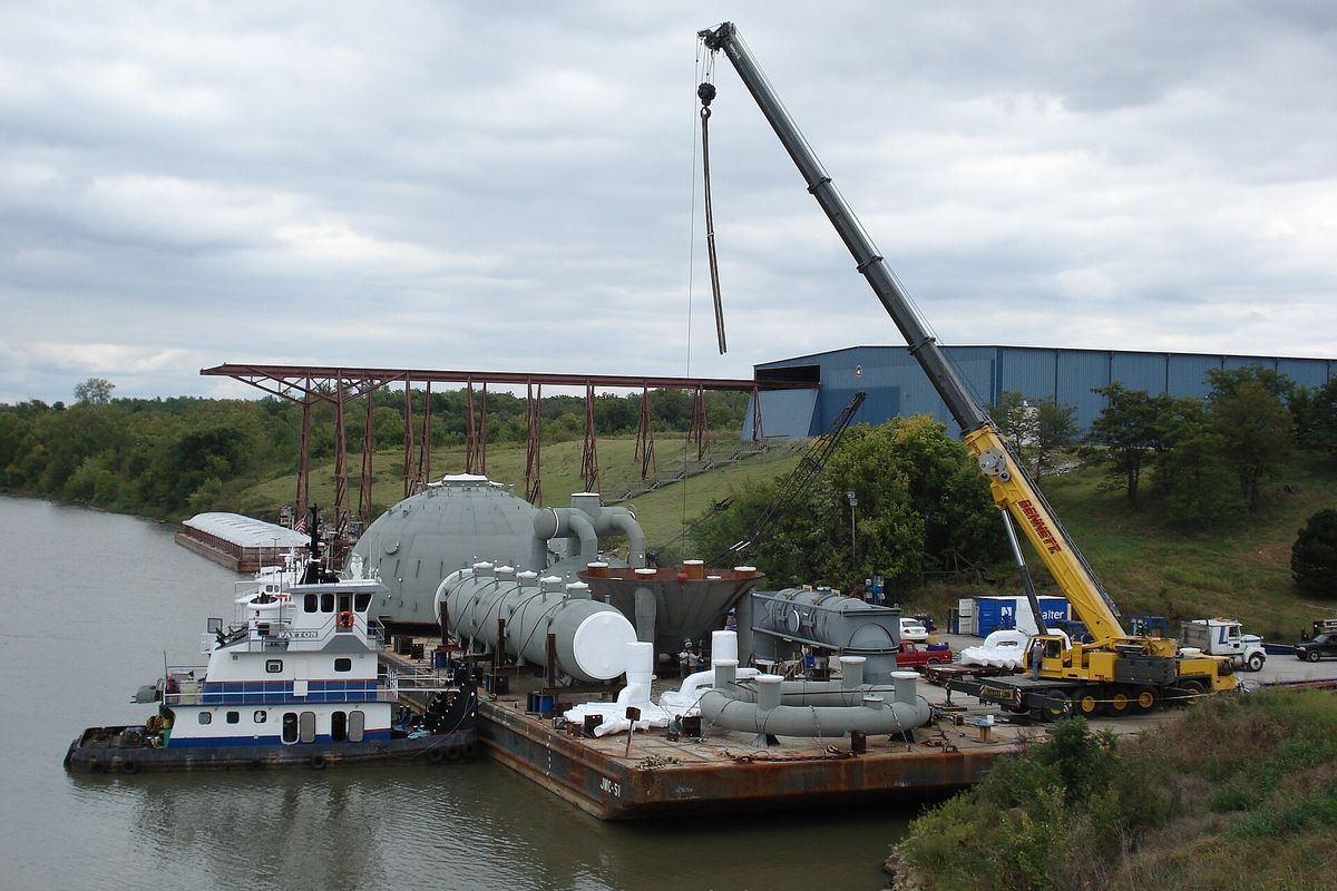 Tugboat and crane moving heavy cargo at the Tulsa Port of Catoosa on the Verdigris River
