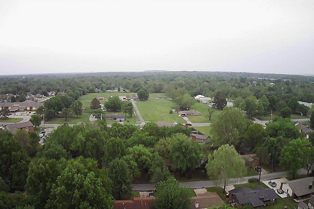 Aerial view over homes, trees, and open ground on the south side of Coweta, Oklahoma