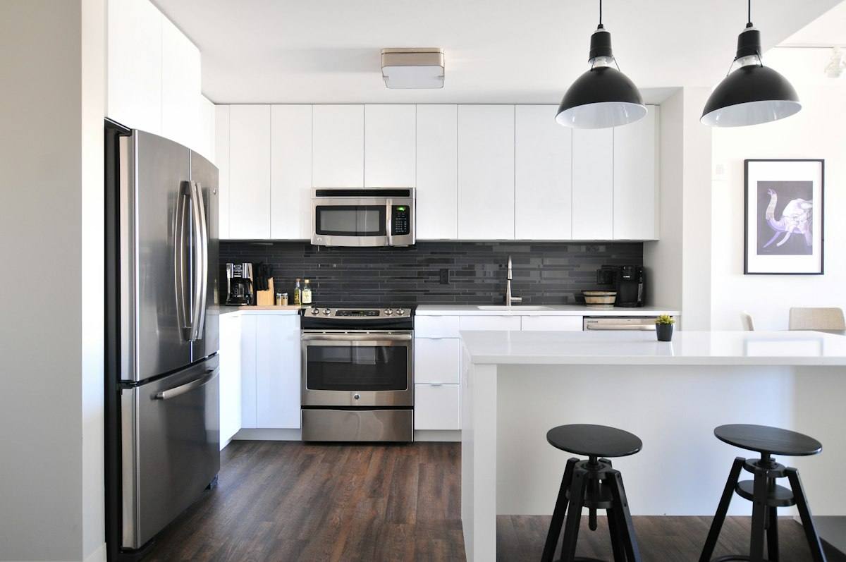 Modern kitchen with wood flooring in a Tulsa OK home, where indoor humidity control protects cabinets and floors after water damage
