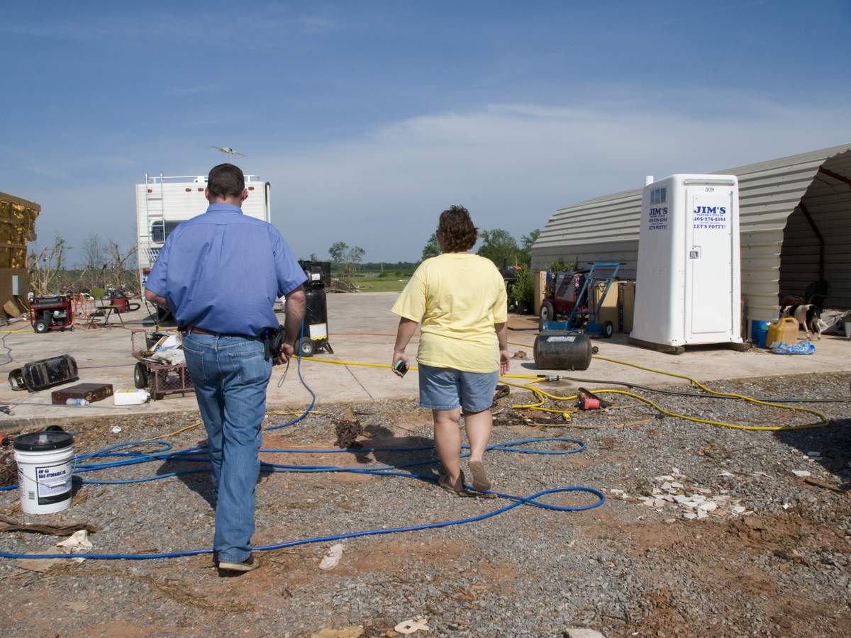 Homeowner and an inspector walking a flood damaged property in Oklahoma as response work begins