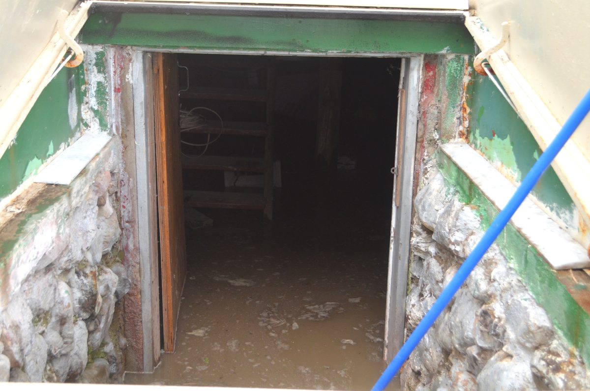 Standing flood water inside a home basement entrance