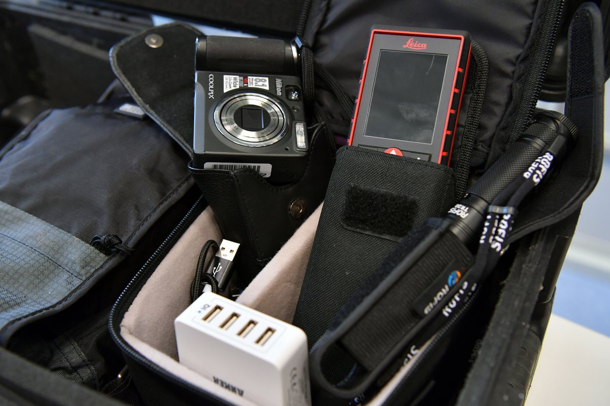 An inspection kit case holding a camera and testing devices