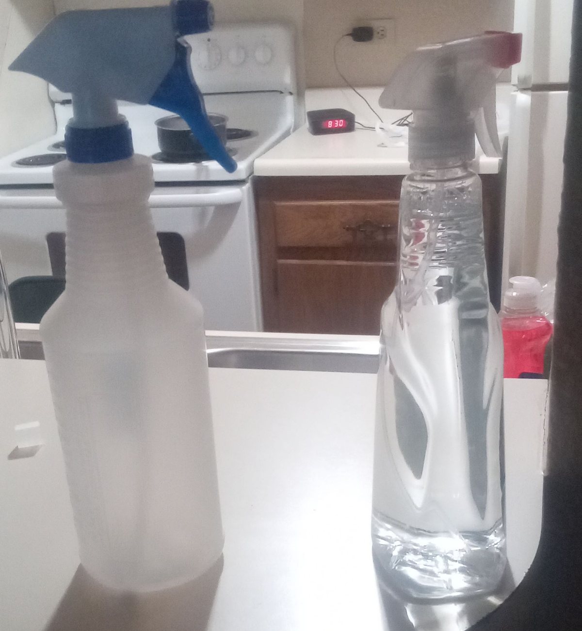 Spray bottles of household cleaner on a kitchen counter