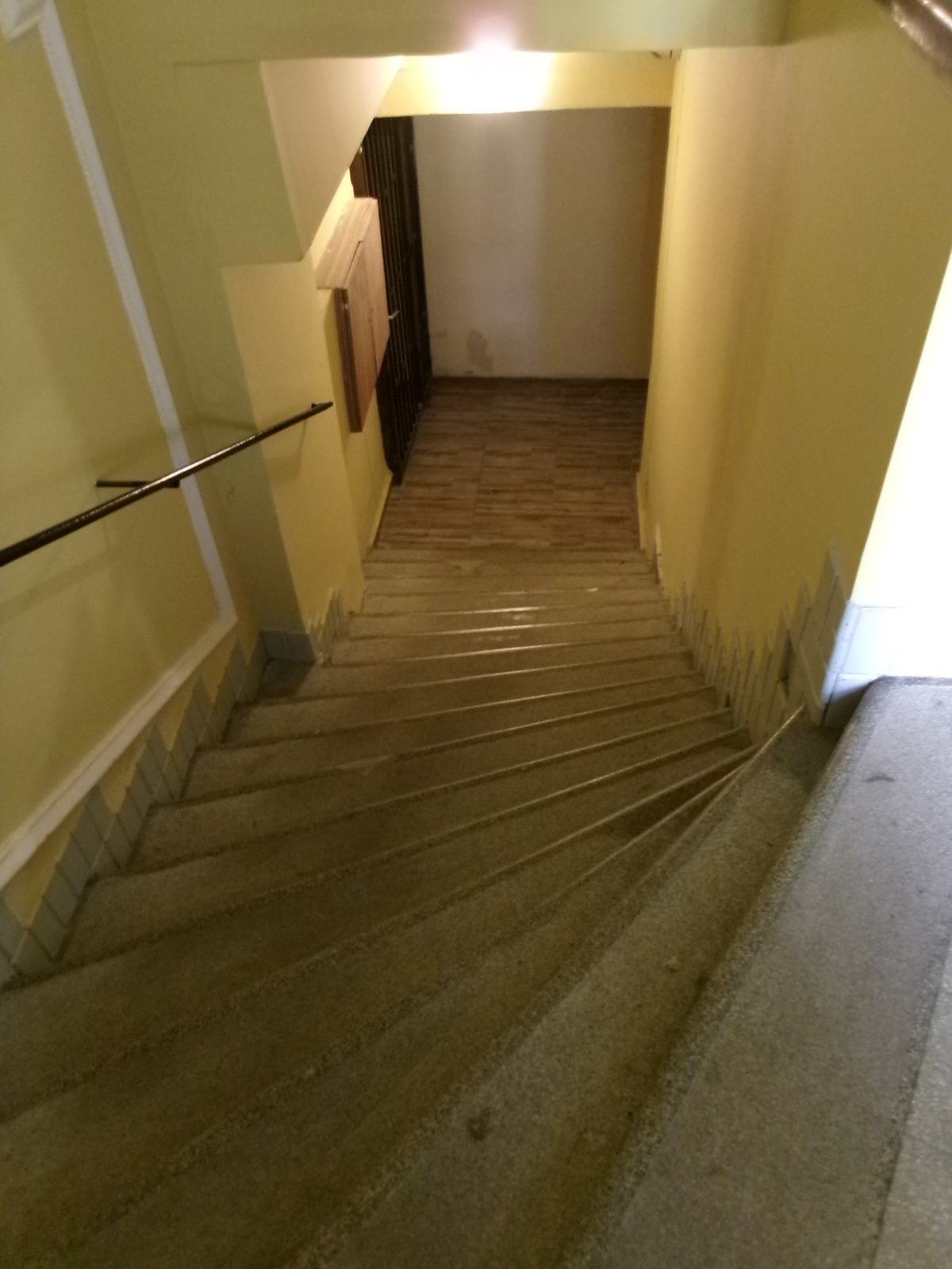 Stairs leading down to a cellar, where trapped moisture feeds musty odors