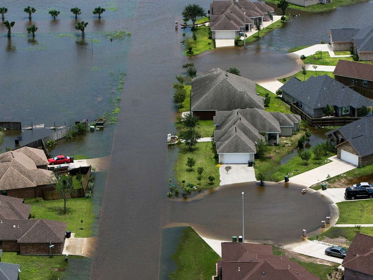Aerial view of floodwater covering a residential street and front yards
