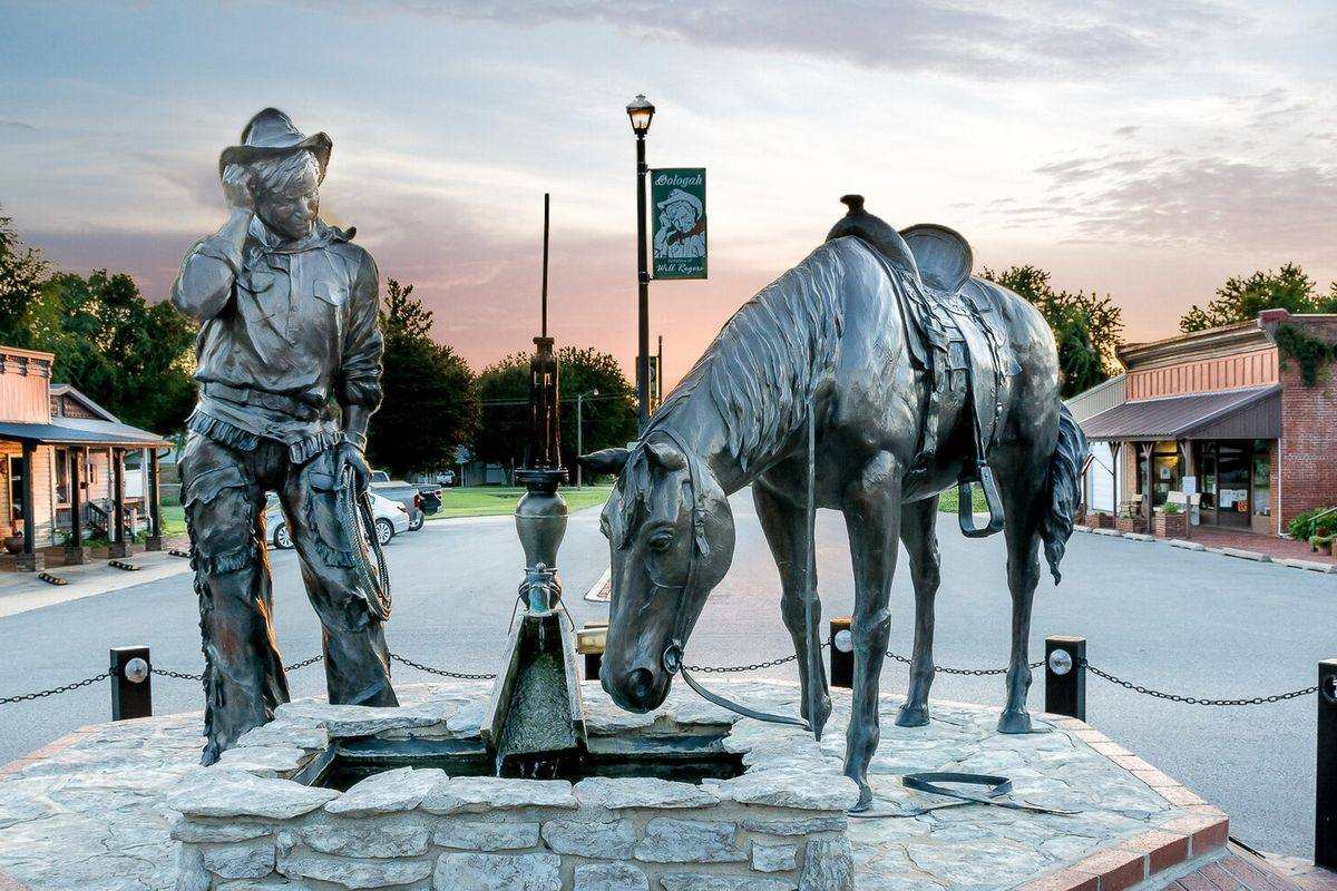 Bronze statue of a cowboy and his horse at a water pump in downtown Oologah, Oklahoma