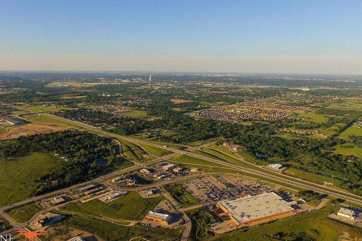 Aerial view of a new housing and commercial development with a highway interchange in the Tulsa metropolitan area