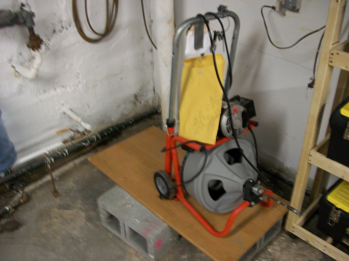 Heavy duty drain cleaning machine used to clear a blocked sewer line