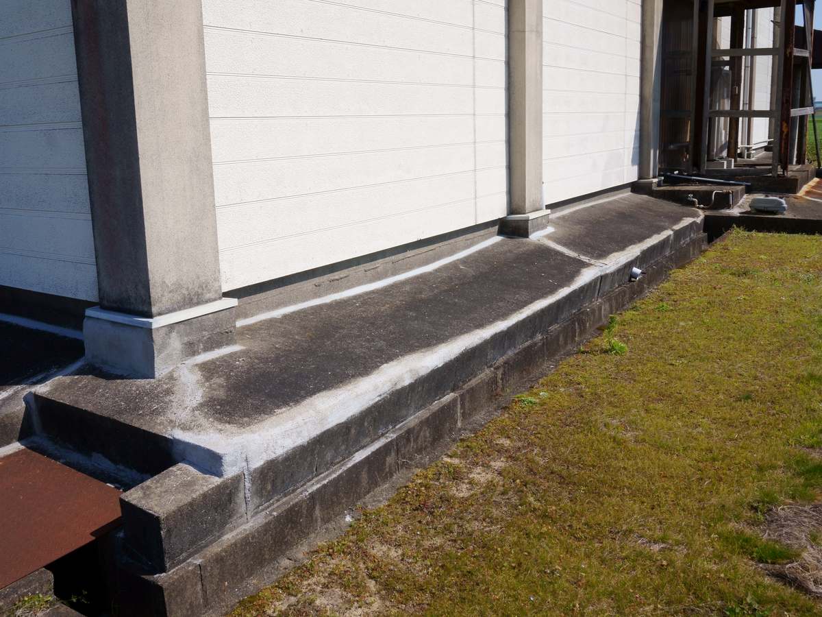 Sealed foundation cracks along the base of a house built on a concrete slab