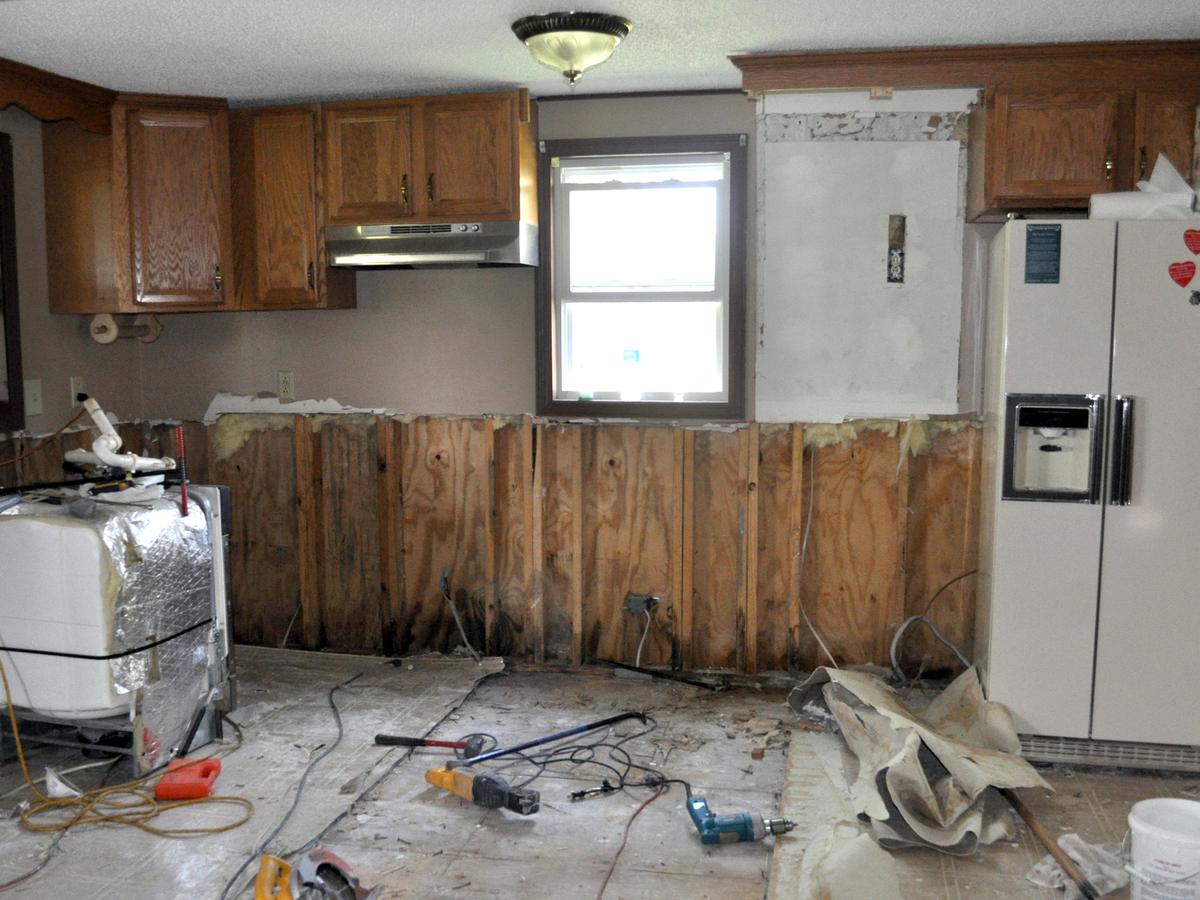 Flood damaged kitchen with drywall removed to the studs so the framing can dry