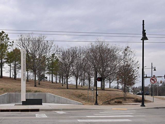 A memorial park with mature trees in the Greenwood area of North Tulsa