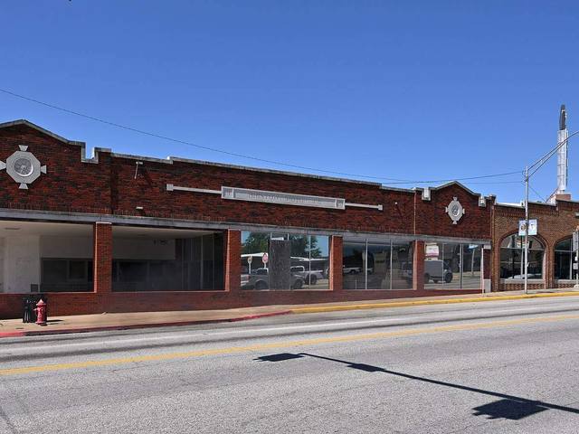 Long brick commercial building on a small town Oklahoma main street, representative of Sperry older core