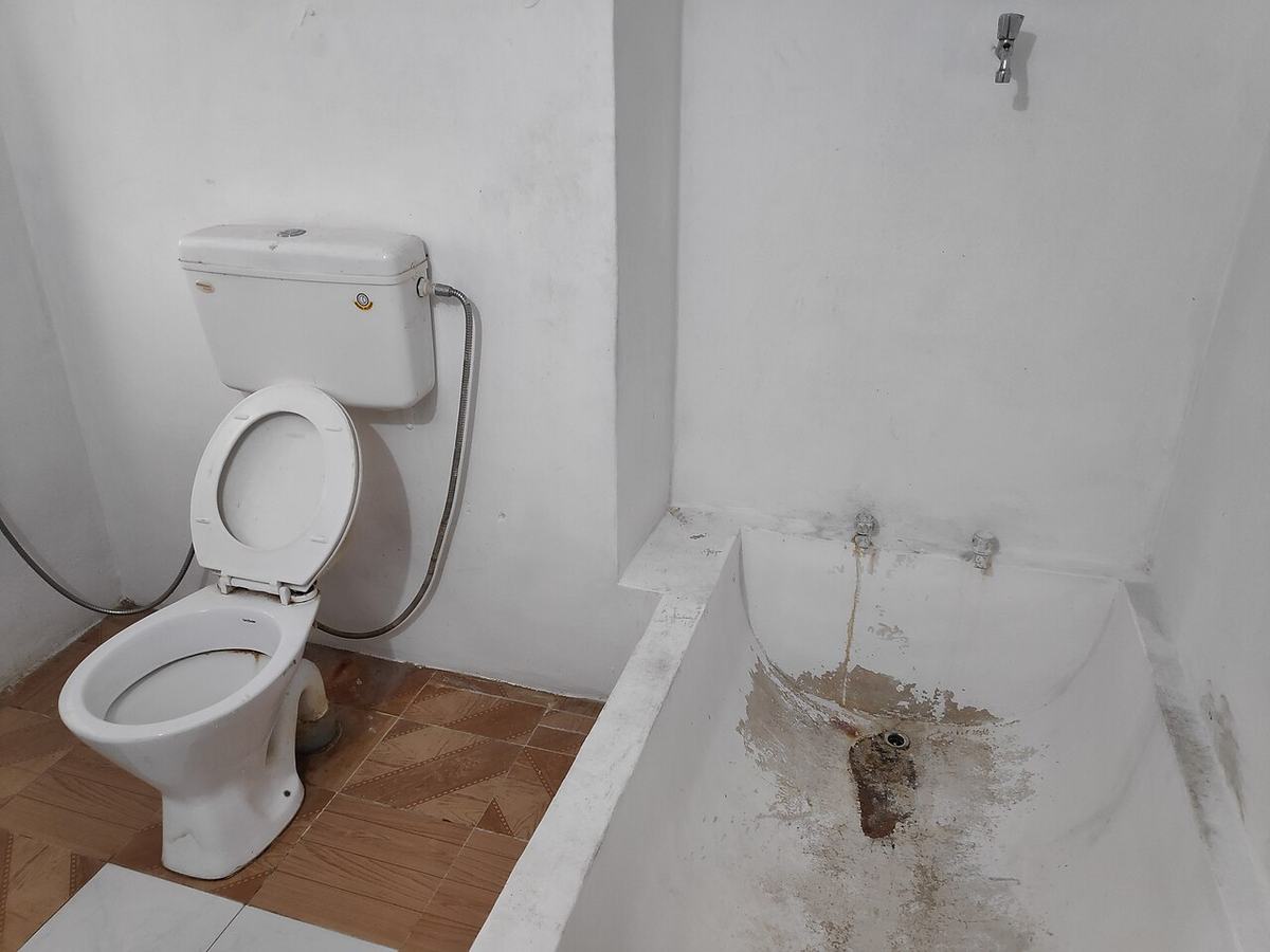 Bathroom toilet and tub in a Tulsa home, where an overflow or failed wax ring can send water across the floor and into the ceiling below