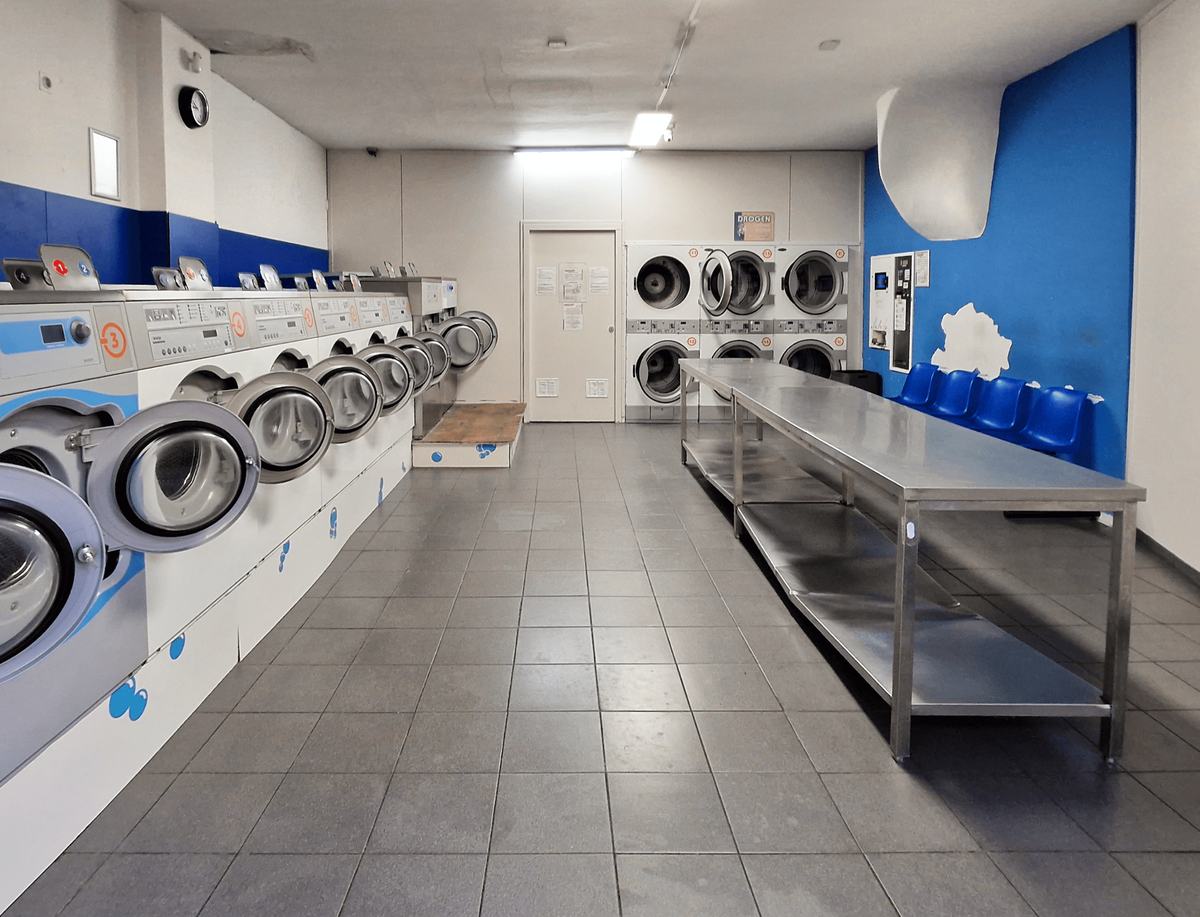 A row of washing machines in a laundromat