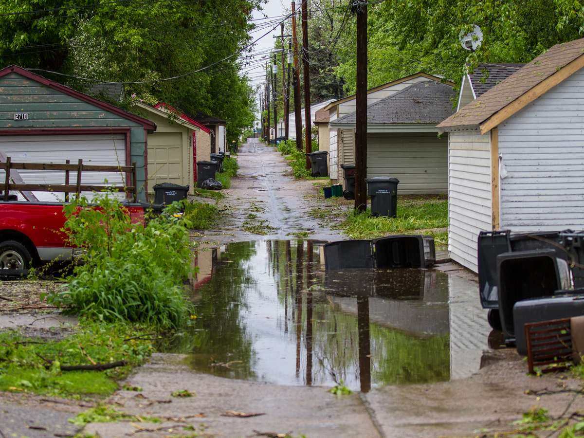 Standing water filling a paved alley after flooding