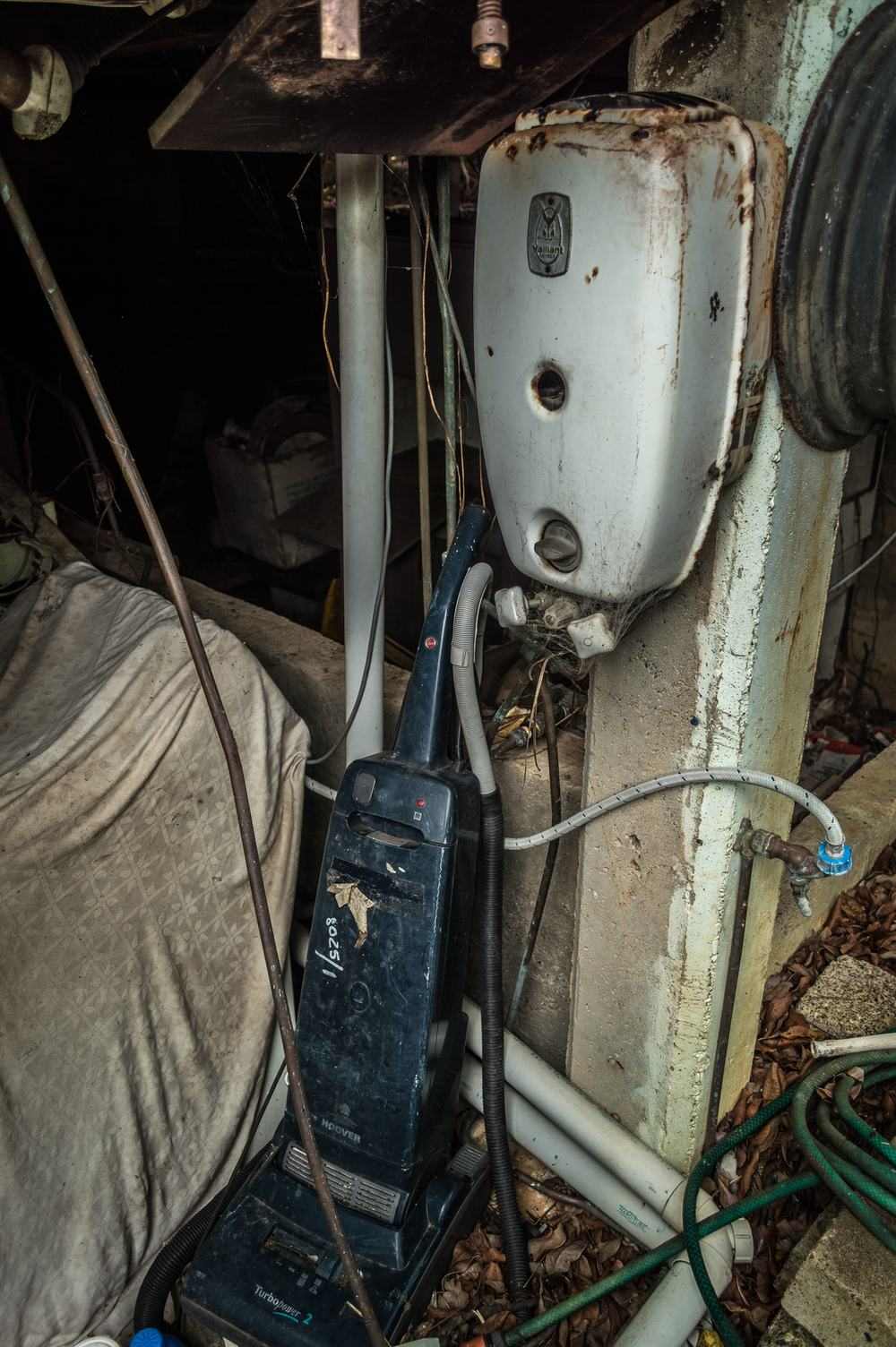 An old water heater with heavy rust around its base